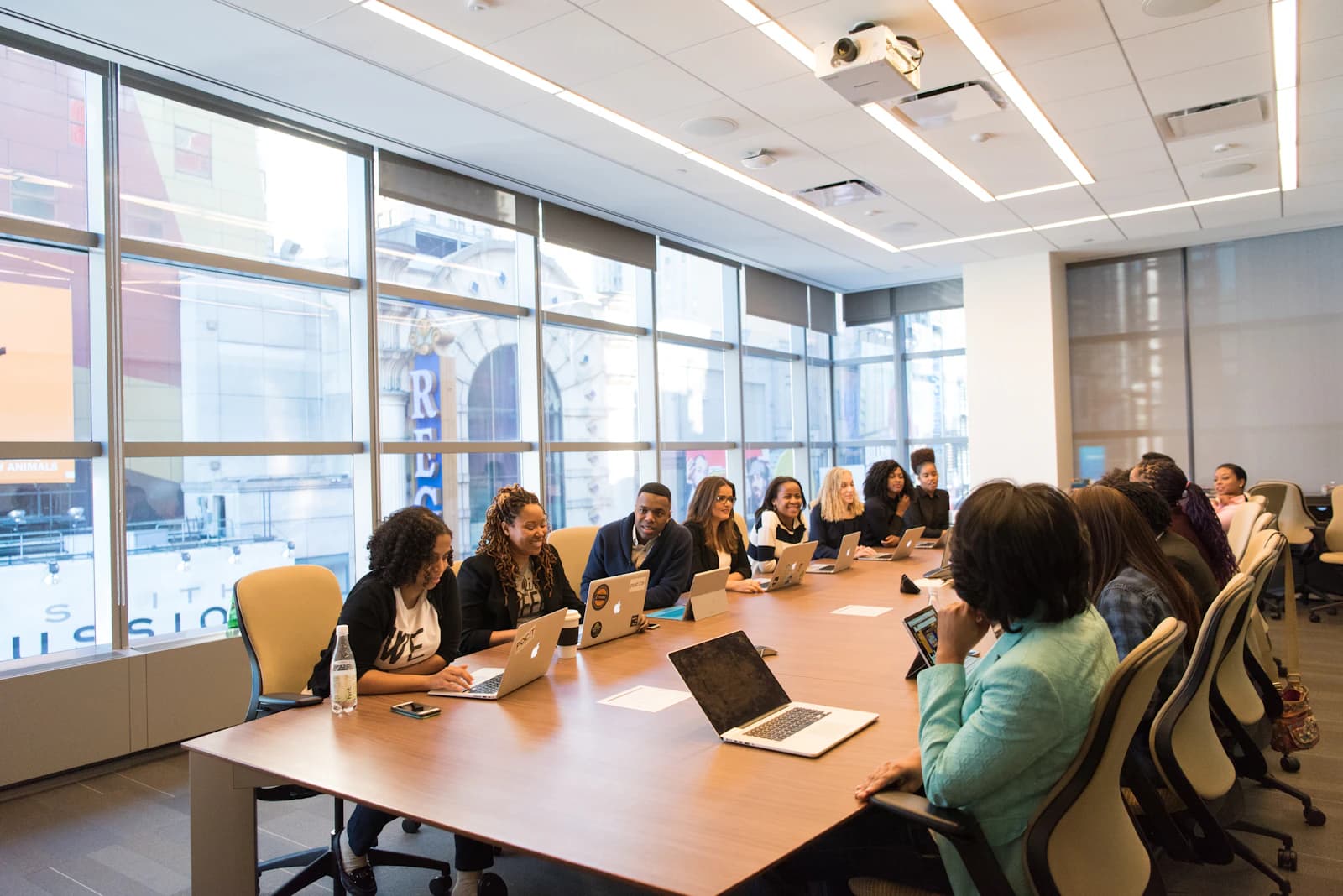 A team of analysts working through a problem around a boardroom table
